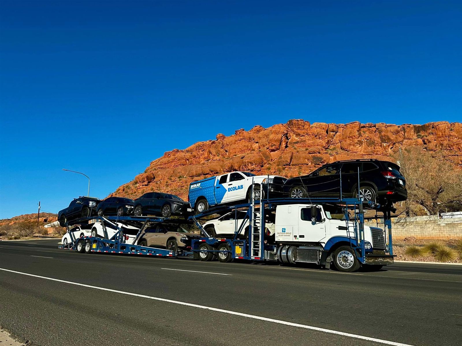 Deltrans Group truck transporting vehicles through the Southwest desert