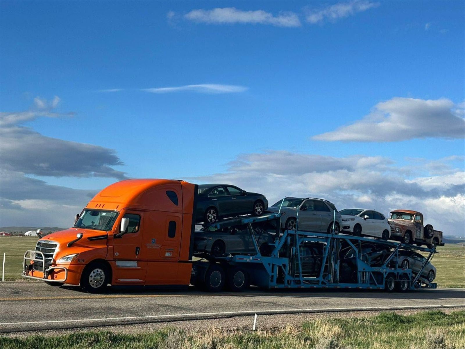 Deltrans Group car carrier truck loaded with vehicles on the open road
